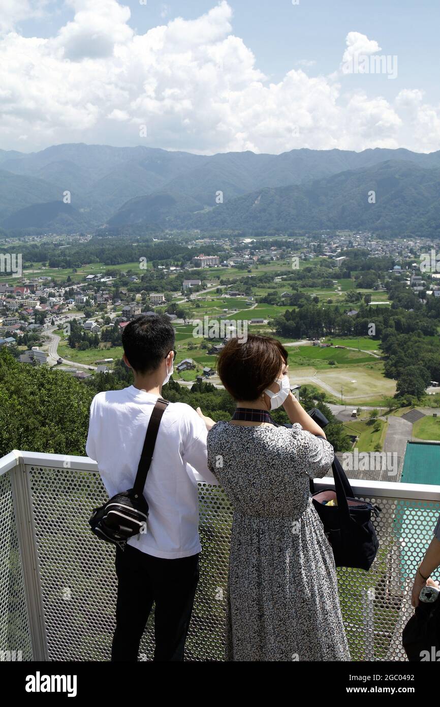 Hakuba, Japan, 2021-24-07 , Tourists enjoying the view from the top of the Ski jump in Hakuba, Japan, that holded the winter olympics in 1998. Stock Photo