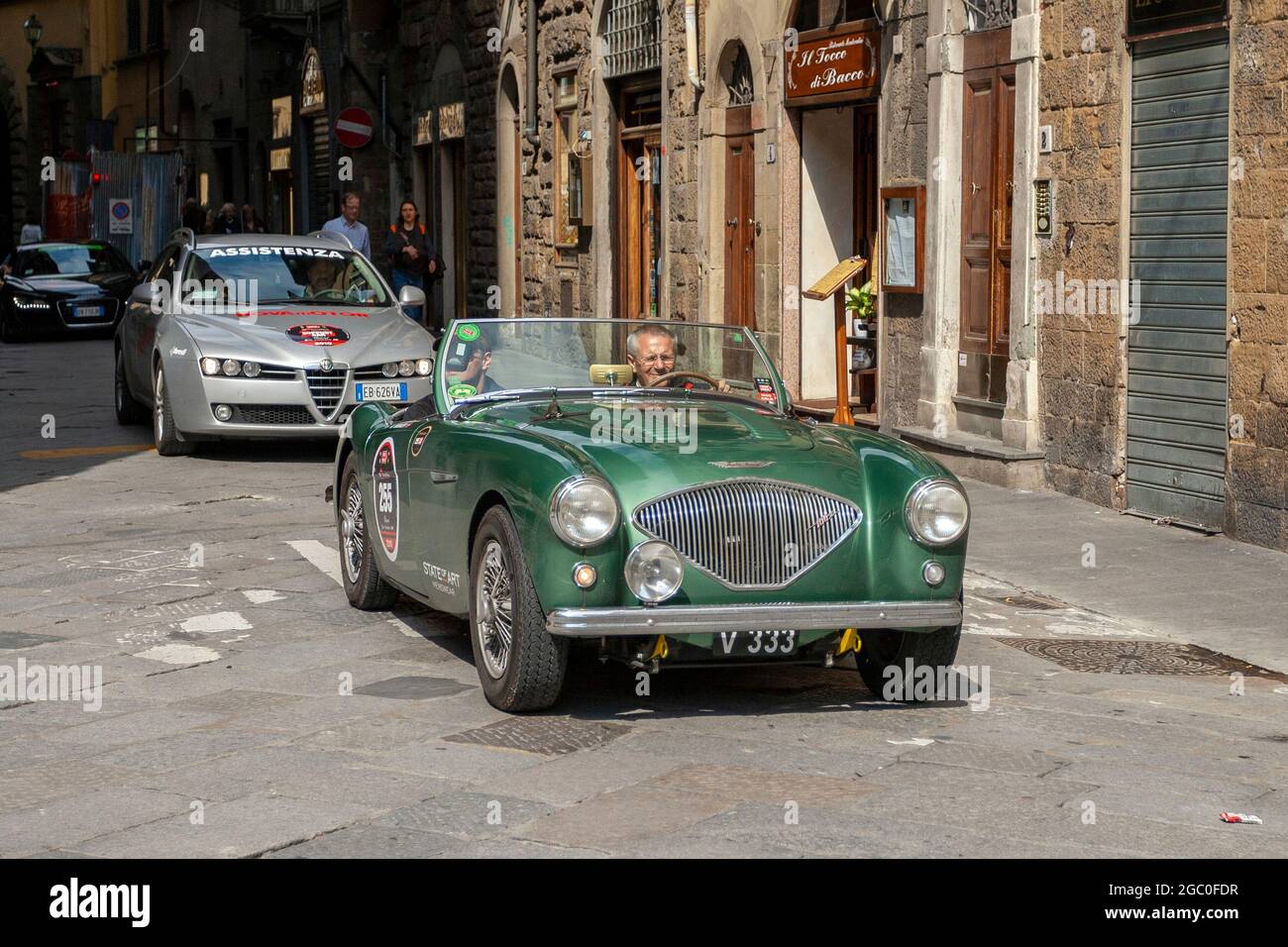 Florence, Italy - May 8, 2010: AUSTIN HEALEY 100 BN1 (1953) in the rally Mille Miglia 2010 edition on a busy street in Florence. Stock Photo