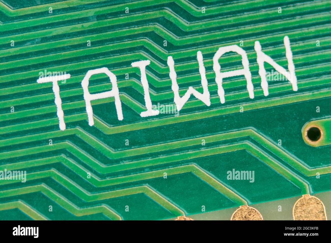 Made in Taiwan printed on the surface of a green pcb circuit board showing traces / connecting wires. For Taiwan electronics industry, foreign trade. Stock Photo