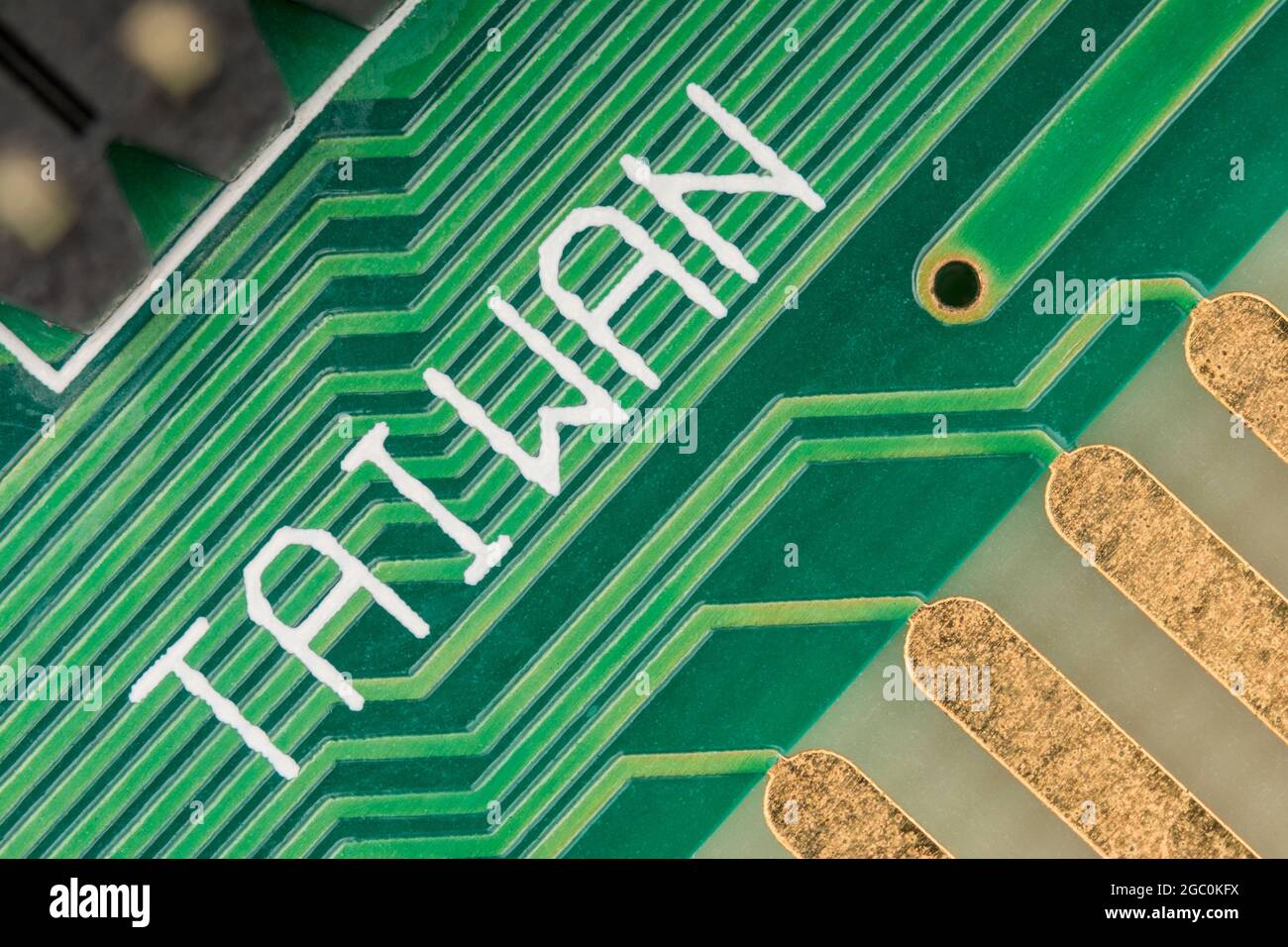 Made in Taiwan printed on the surface of a green pcb circuit board showing traces / connecting wires. For Taiwan electronics industry, foreign trade. Stock Photo