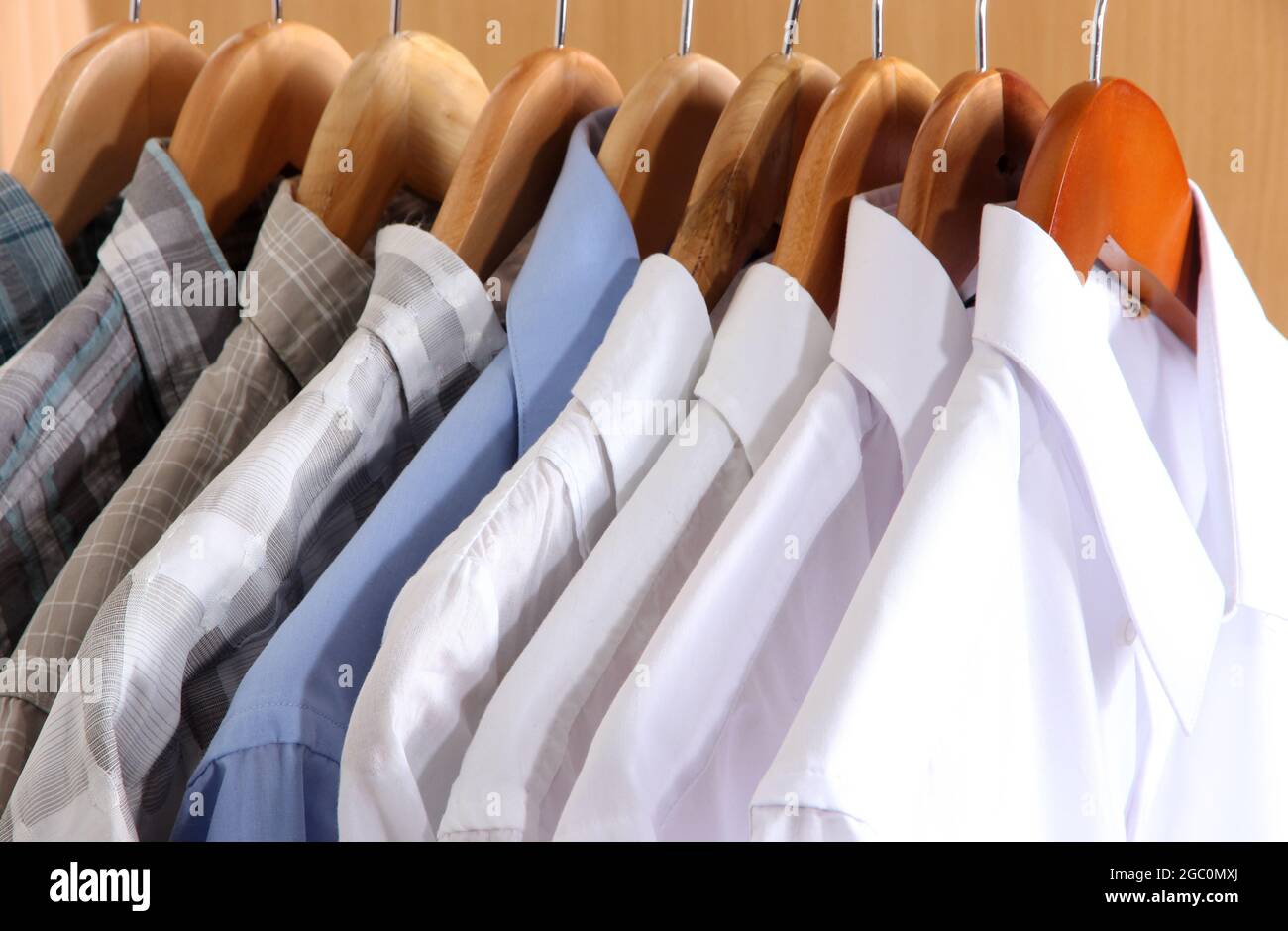 Men's shirts on hangers in wardrobe Stock Photo Alamy