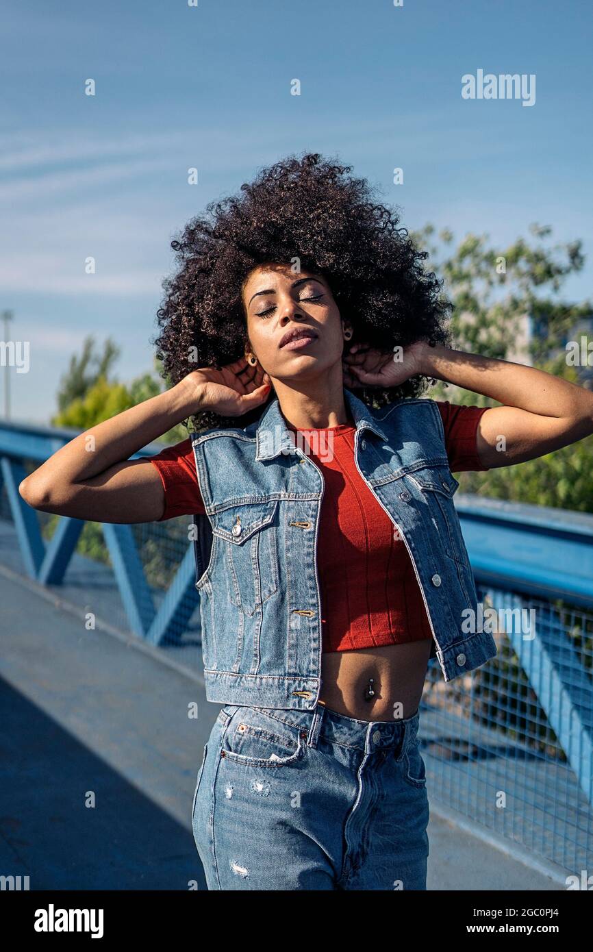 Beautiful african woman with afro hair posing and having fun in the ...