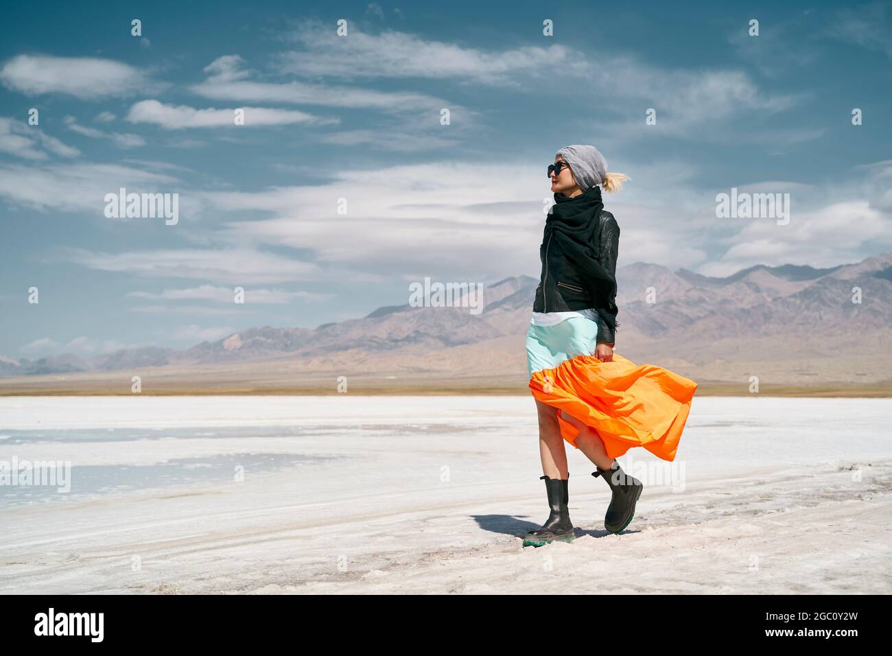 asian woman female tourist in long skirt walking on saline alkali land Stock Photo