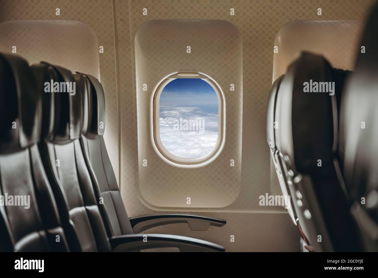 Airplane window in clear sunny weather. Interior of a passenger plane with an open window in flight. High quality photo Stock Photo