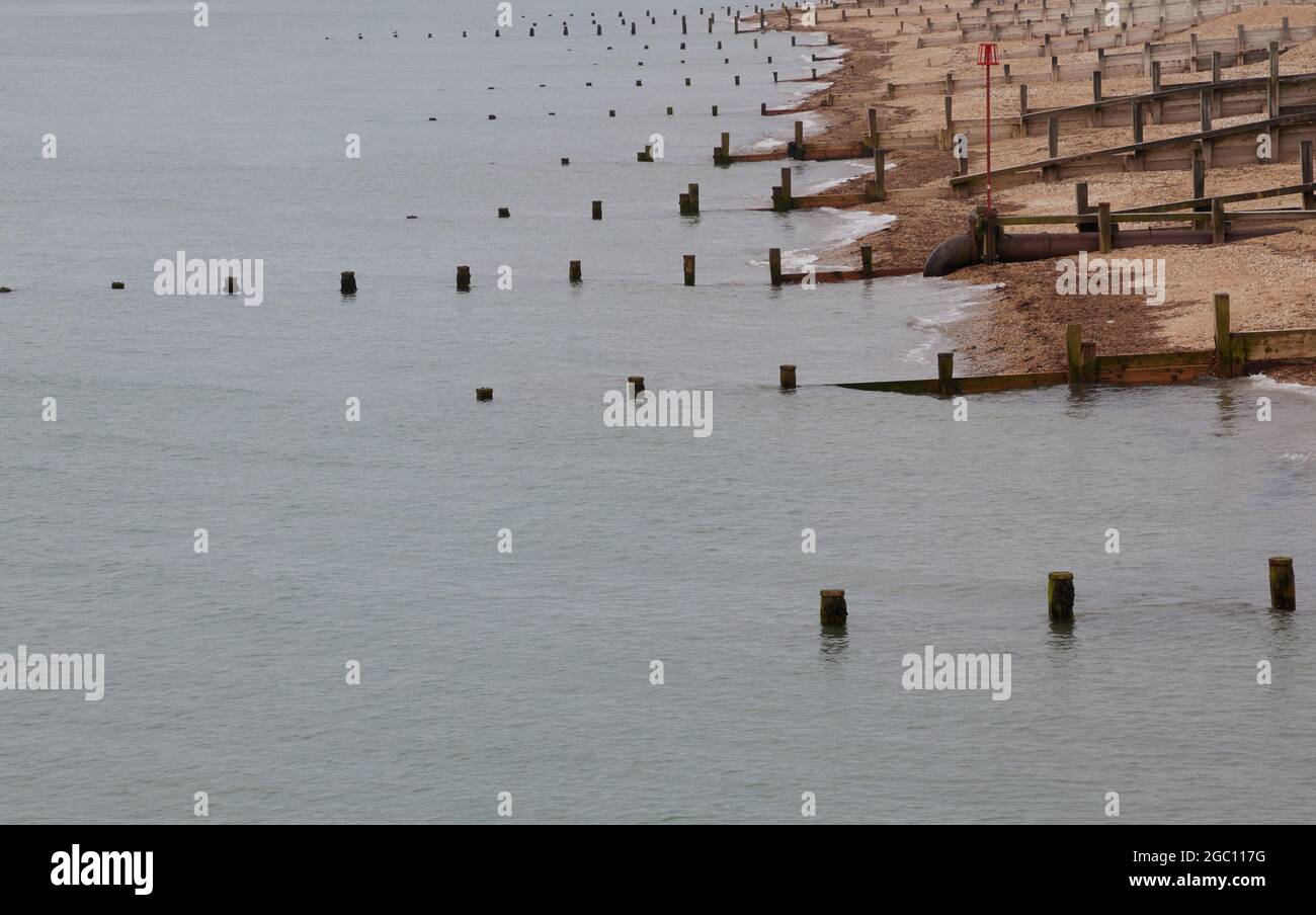 Groynes seen on the beach of Bognor Regis slowing down any beach erosion. Stock Photo