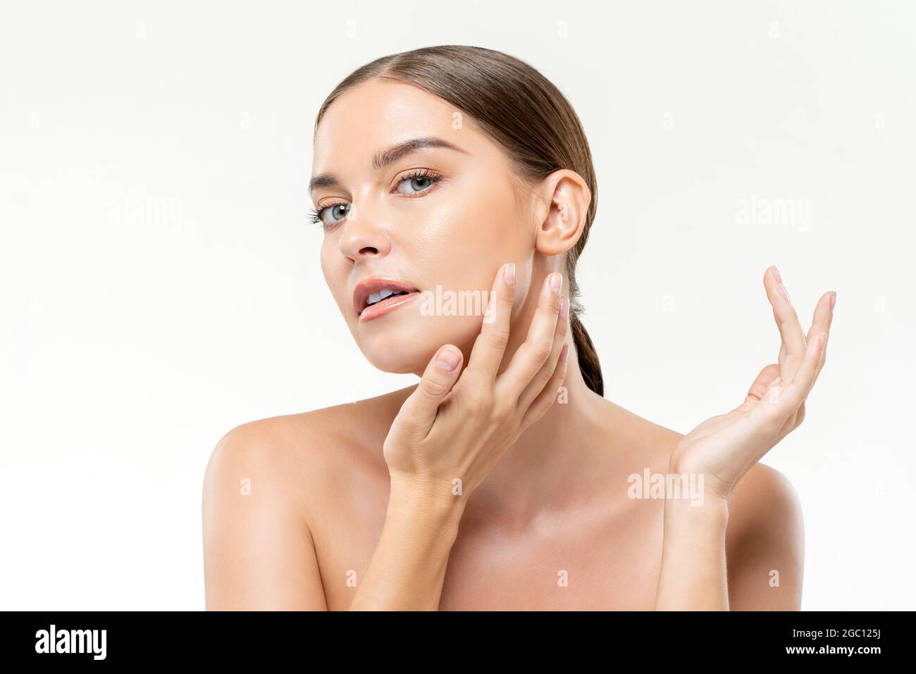 Beauty shot of caucasian woman with youthful fresh clear wrinkle free face skin in isolated studio white background Stock Photo