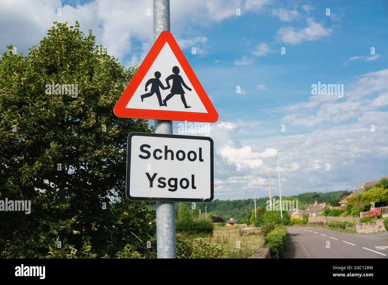 Bilingual school crossing warning sign in Welsh and English languages in rural North Wales UK Stock Photo