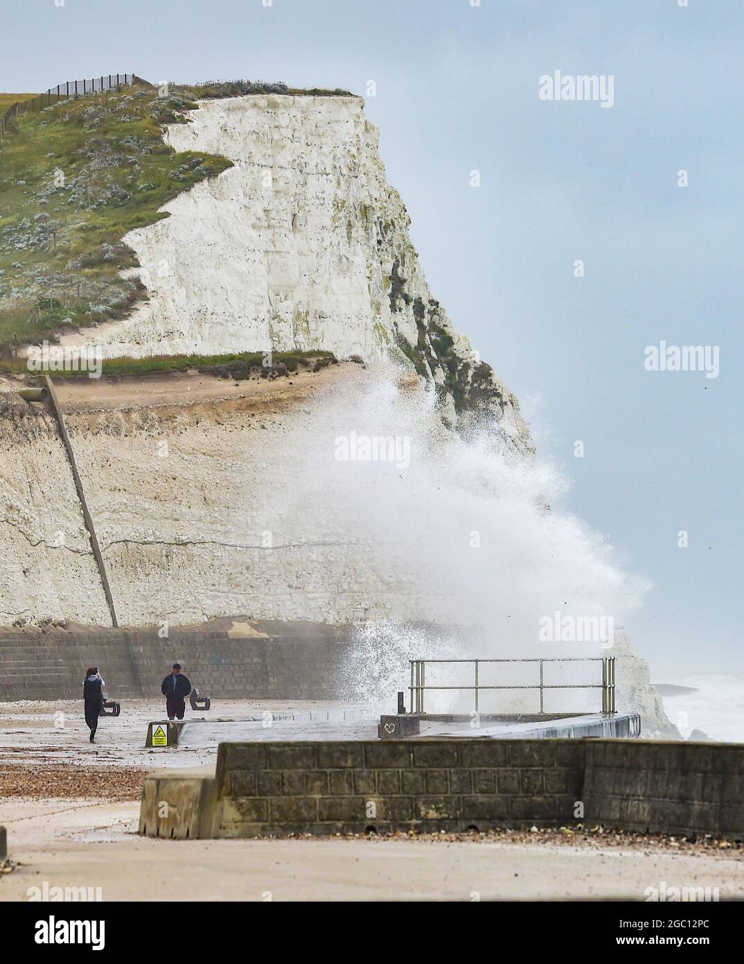 Brighton UK 6th August 2021 - Huge waves crash over the undercliff walk at Saltdean near Brighton as more storms batter the South Coast today : Credit Simon Dack / Alamy Live News Stock Photo