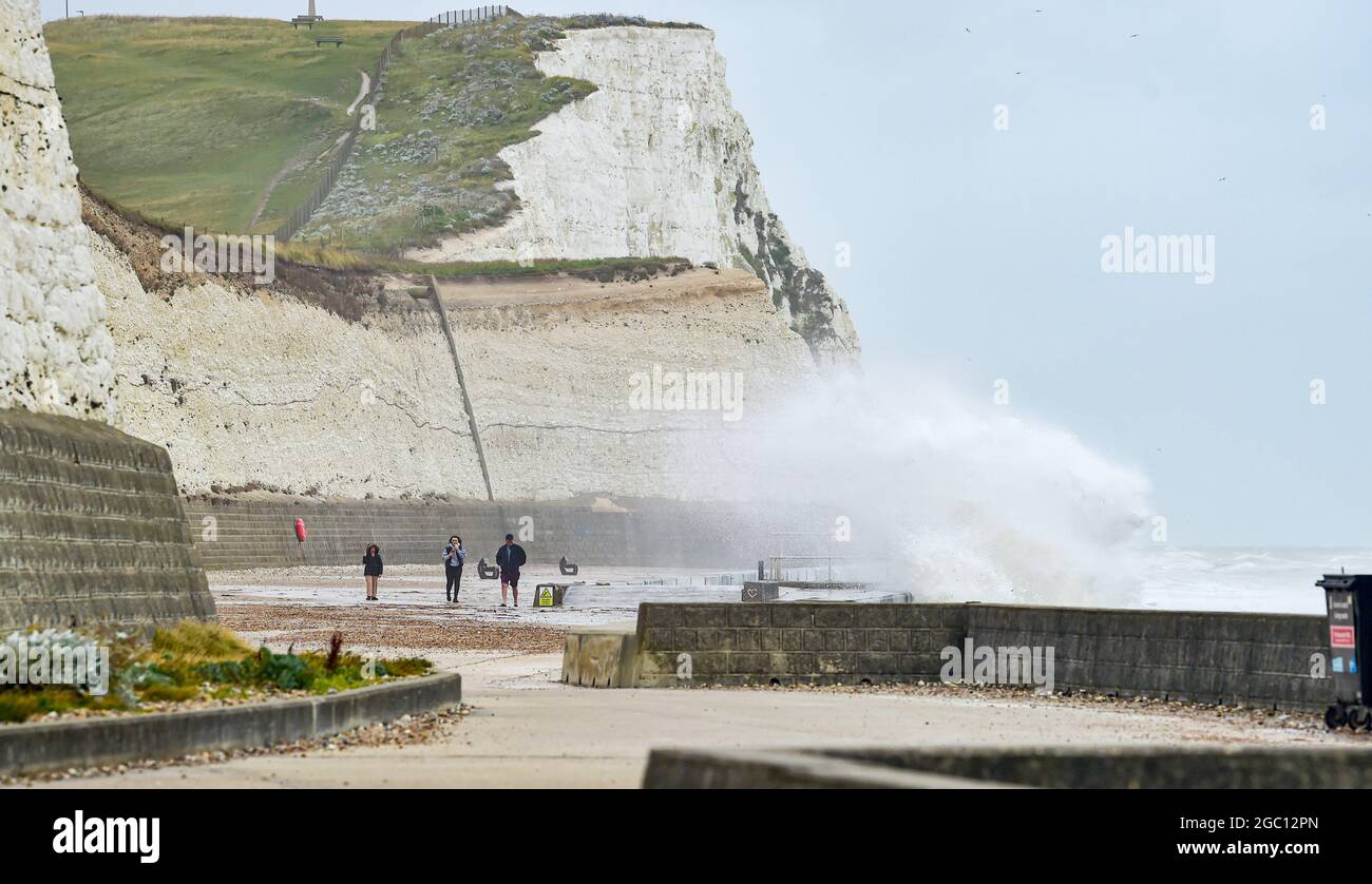 Brighton UK 6th August 2021 - Huge waves crash over the undercliff walk at Saltdean near Brighton as more storms batter the South Coast today : Credit Simon Dack / Alamy Live News Stock Photo