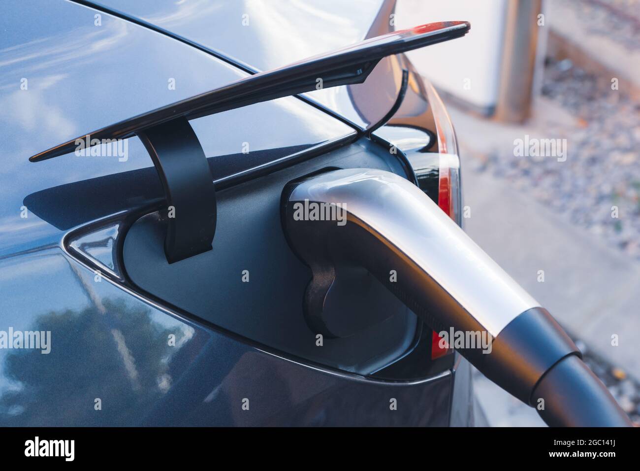 EV Car or Electric vehicle at charging station with the power cable supply plugged in for charge the battery. The future of the Automobile and Eco-fri Stock Photo