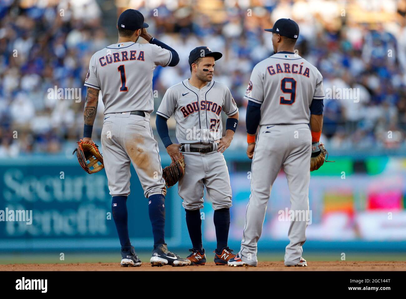 Houston Astros infielders Carlos Corréa, Jose Altuve, and Robel Garcia talk on the infield during an MLB regular season game against the Los Angeles D Stock Photo