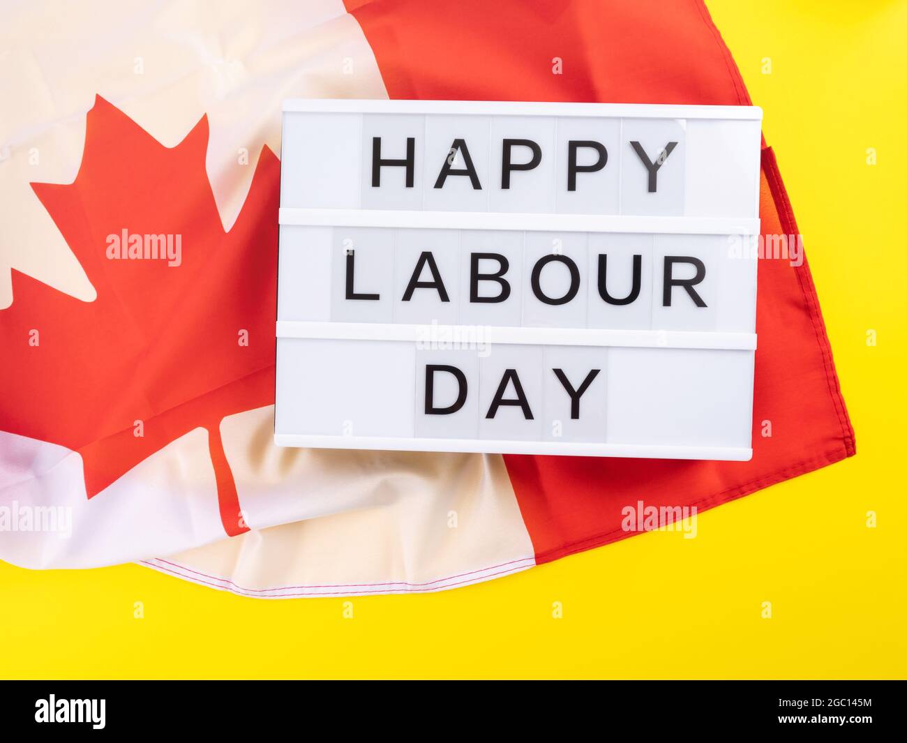 Happy Labour Day greetings on lightbox with canadian flag Stock Photo