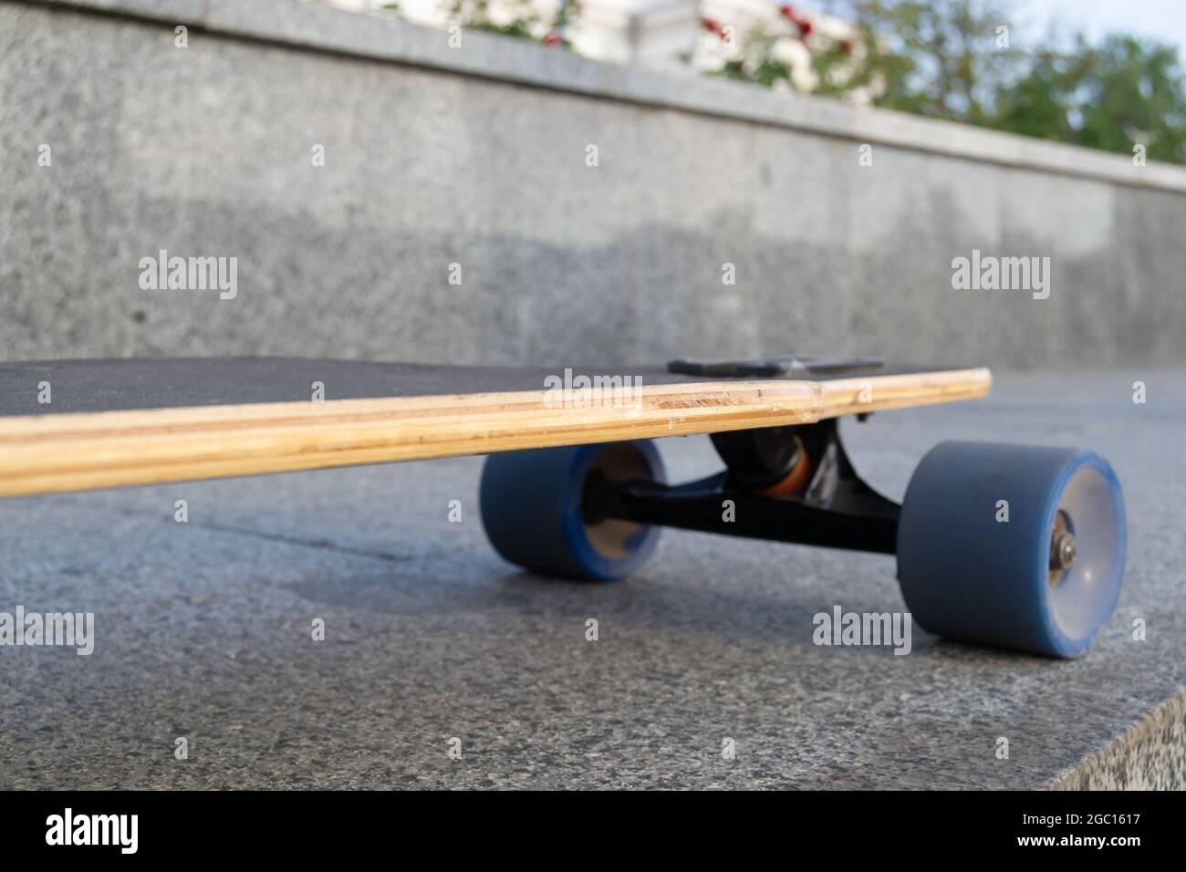 Closeup to skateboard trucks and wheels on rough asphalt road Stock
