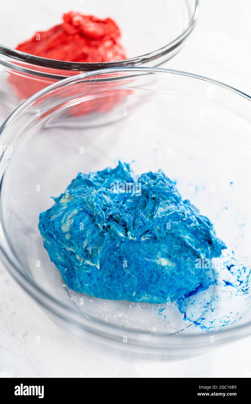 Mixing into the bread dough red and blue food coloring to bake