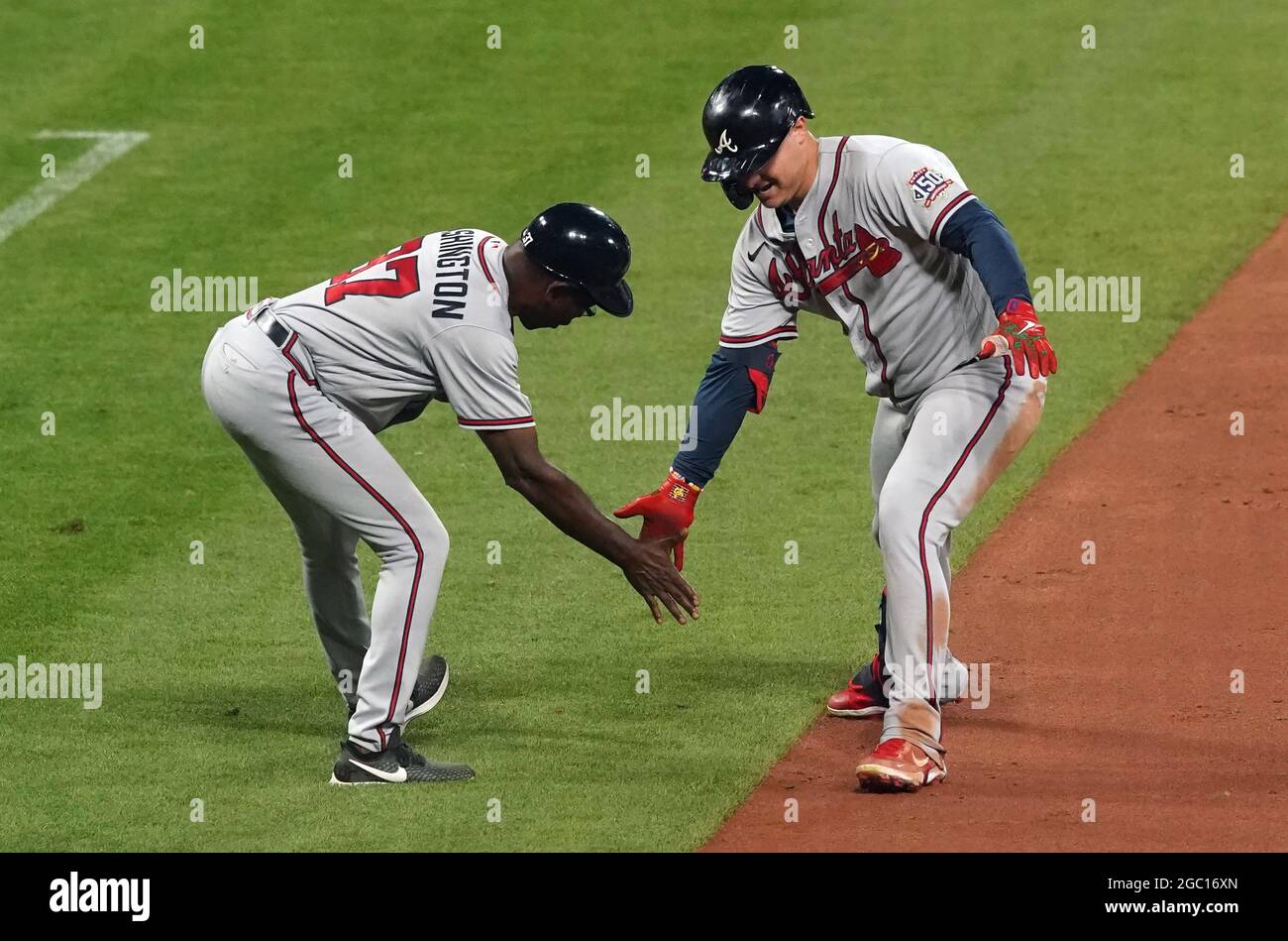 St. Louis, United States. 06th Aug, 2021. Atlanta Braves Joc Pederson slaps  hands with third base coach Ron Washington after hitting a solo home run  against the St. Louis Cardinals in the