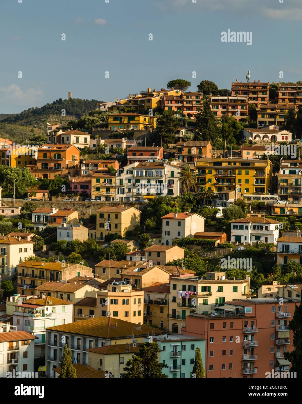 Houses overlooking the harbour in Porto Santo Stefano, one of the two main harbours on the side of Monte Argentario, in Tuscany, Italy. Stock Photo