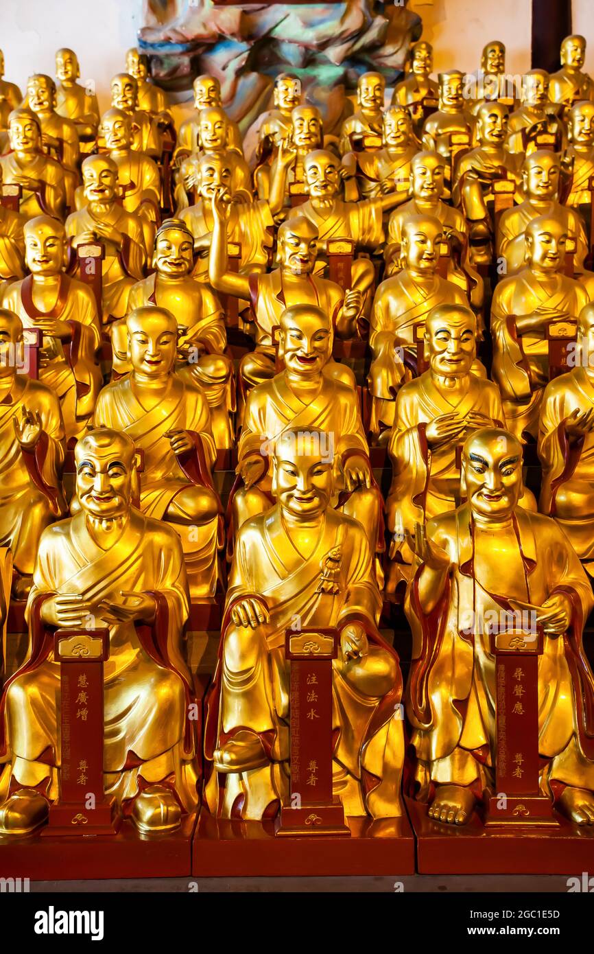 Gold statues of arhats in Longhua buddhist temple in Shanghai, China Stock Photo