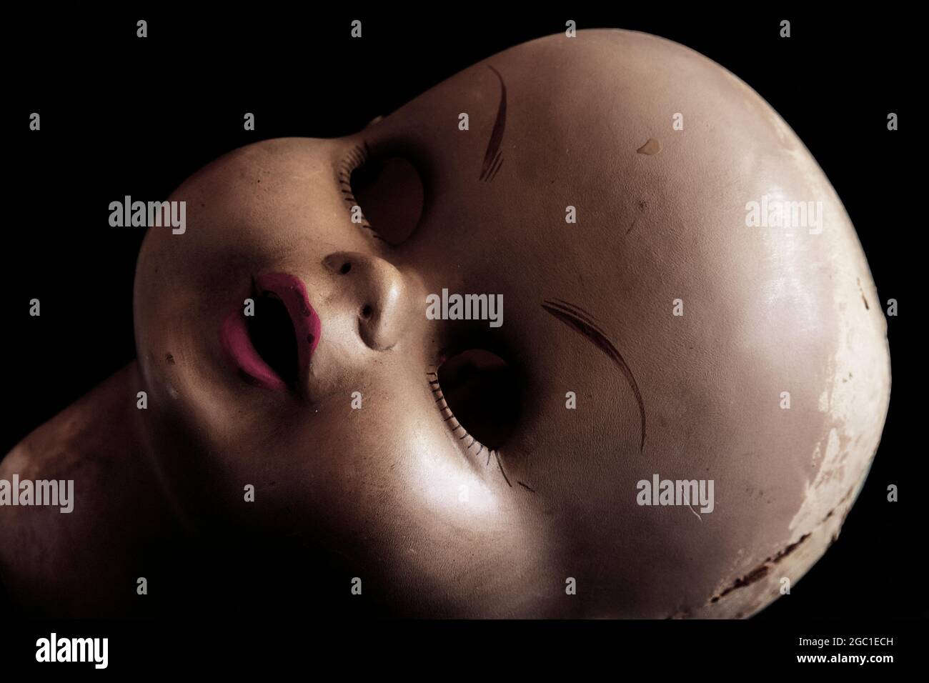 Disturbing image of an old doll's head Stock Photo