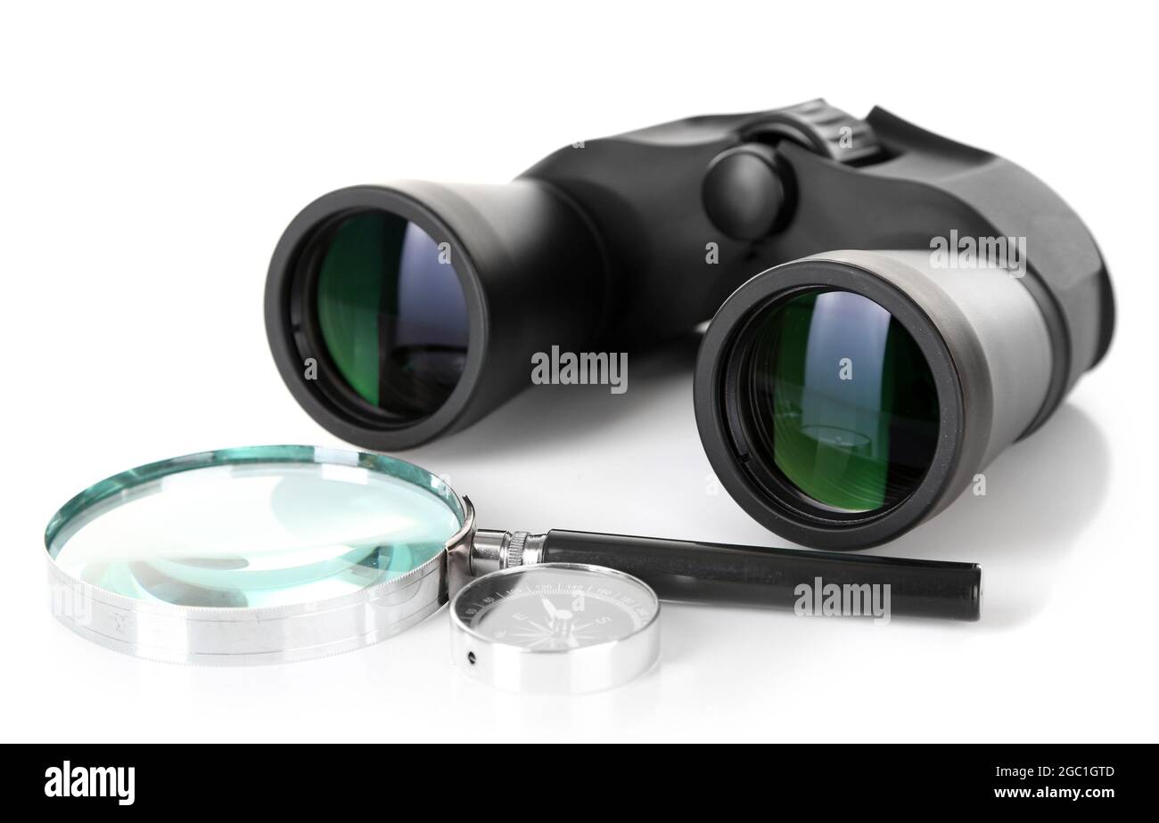 Black modern binoculars with magnifying glass and compass isolated on white Stock Photo Alamy