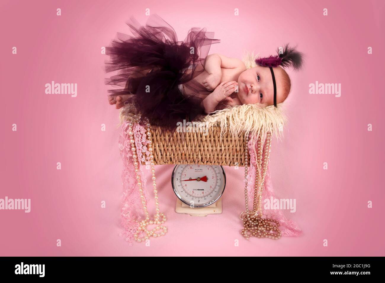 new born baby girl in scales Stock Photo