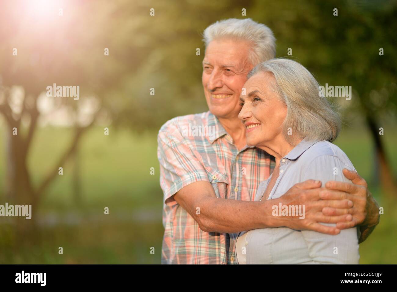 Portrait of senior couple posing in the park Stock Photo - Alamy