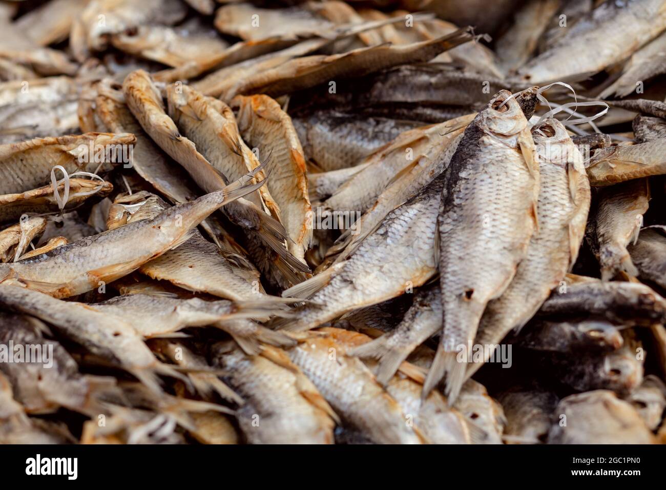 Heap of salted dried fish on string on the market. Traditional Russian