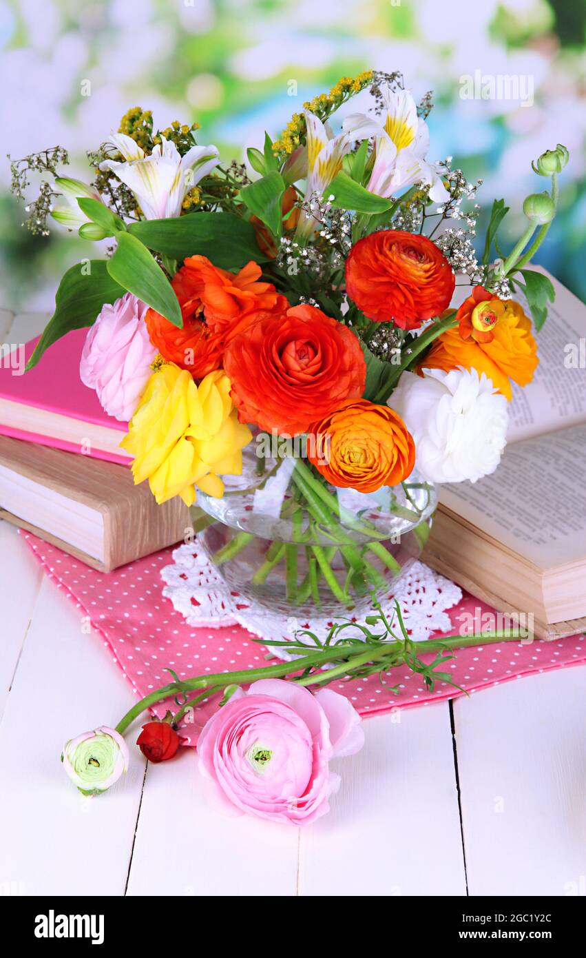 Scenic still life of flowers buttercups on wooden table on natural