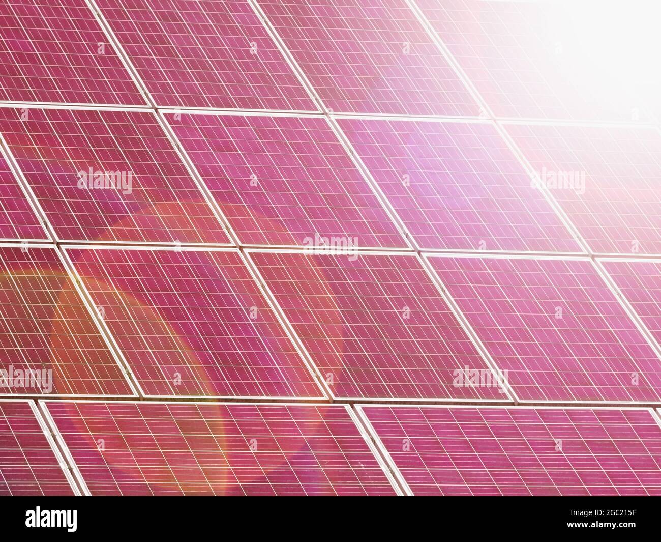 Solar panels with red reflection and strong Sun flares. green energy power solar cell install on roof Stock Photo - Alamy