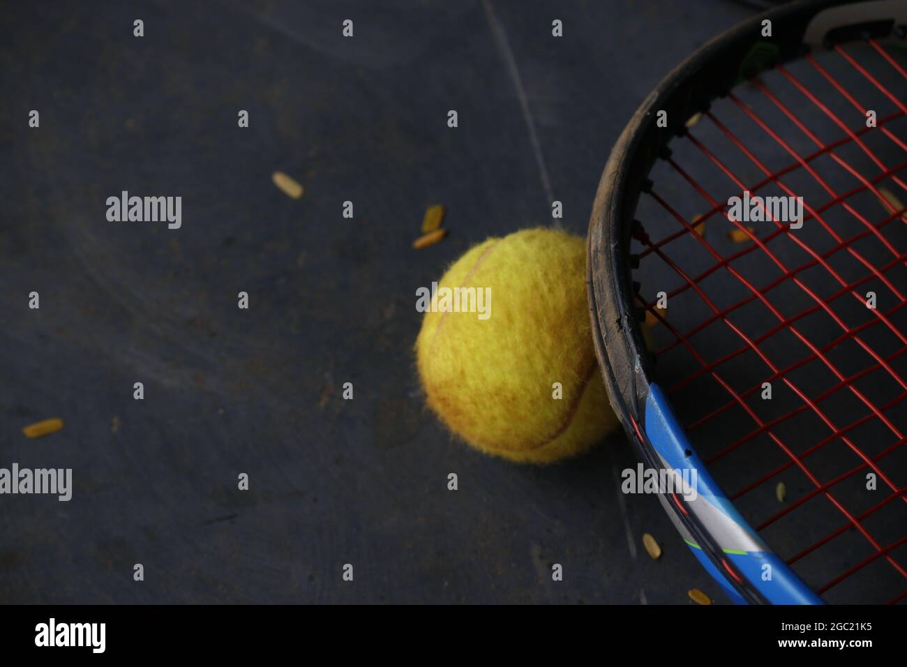 Closeup of a tennis ball ???? ??? tennis racquet on the ground Stock Photo Alamy