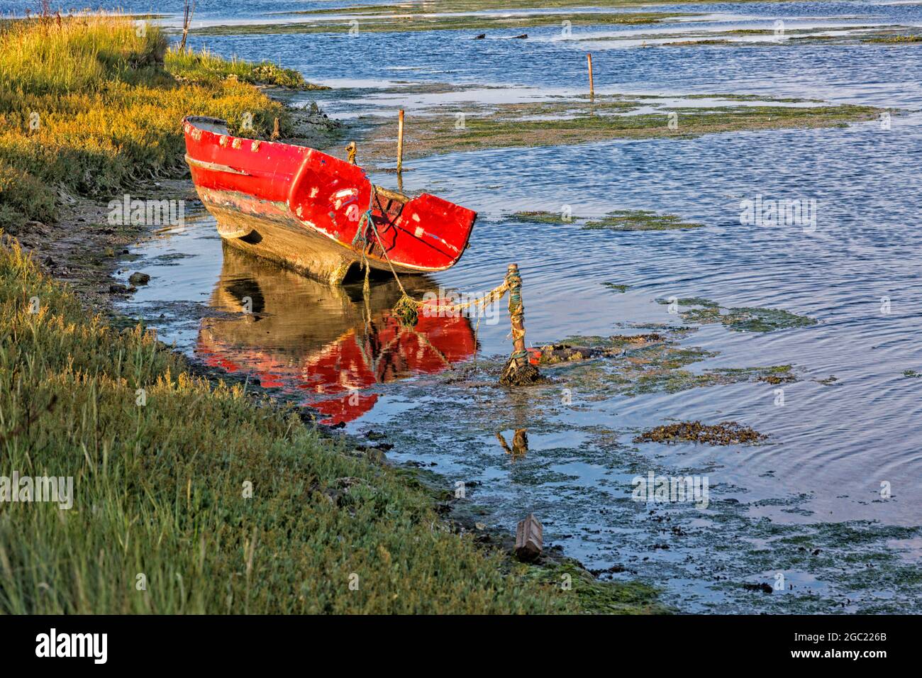 red wooden boat at Holes Bay, Hamworthy, Poole, Dorset UK in August Stock Photo