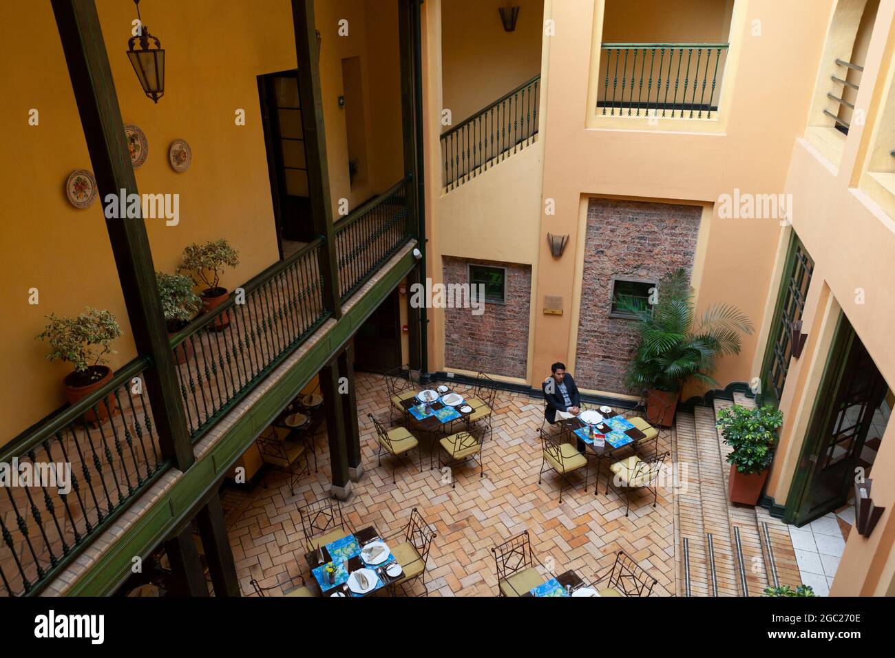 Breakfast is served in the courtyard restaurant of the Hotel de la Opera in Bogota, Colombia. Stock Photo