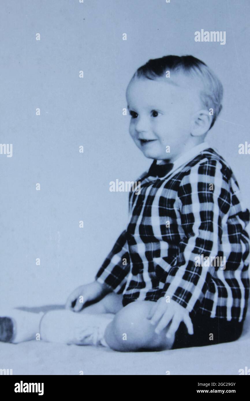 An old photo of a smiling baby boy. Stock Photo