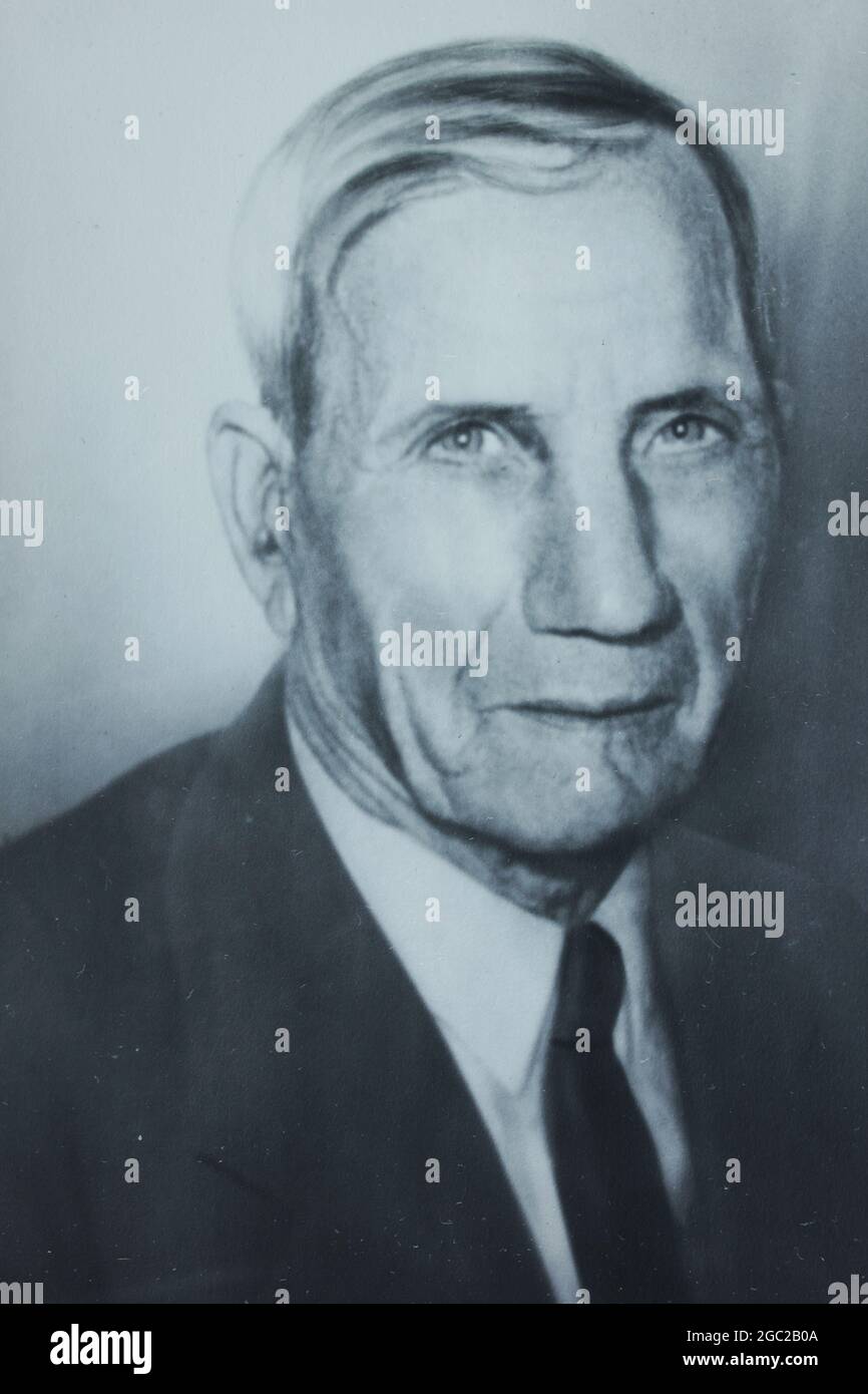 An old photo of an elderly man posing for a formal portrait. Stock Photo