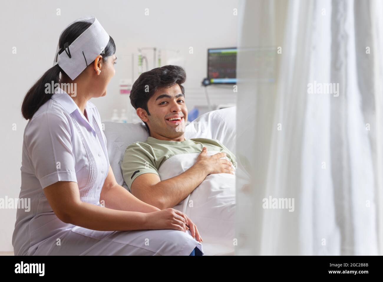 A BOY LYING ON HOSPITAL BED WHILE NURSE ATTENDING Stock Photo - Alamy
