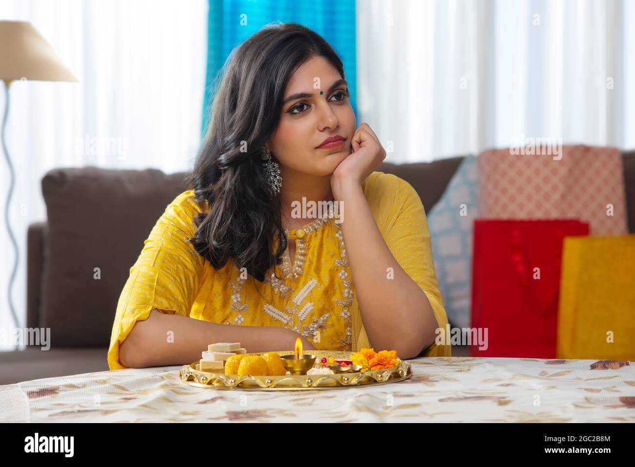 PORTRAIT OF A YOUNG WOMAN SITTING AND WAITING TO DO RAKSHA BANDHAN ...
