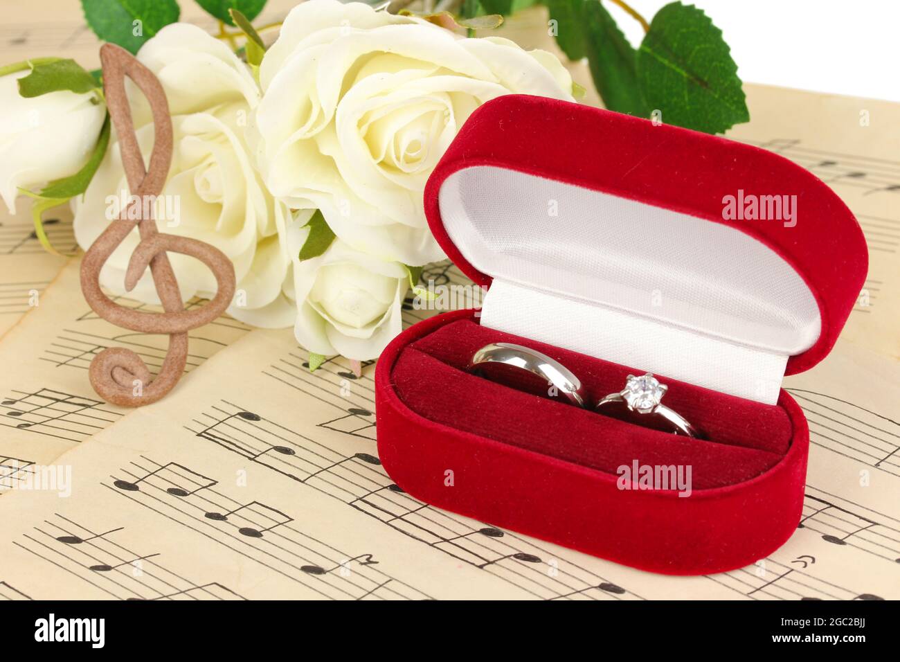 Clef Notes With Roses Treble clef, roses and box holding wedding rings on musical background ...