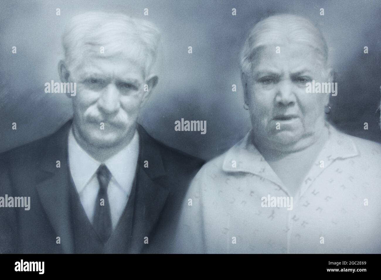 An old photo of a stoic elderly couple. Stock Photo