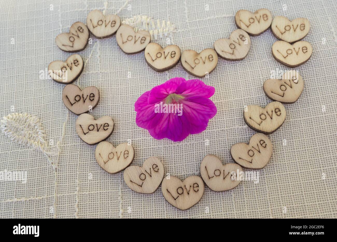 Small wooden love hearts in the shape of a heart. Stock Photo