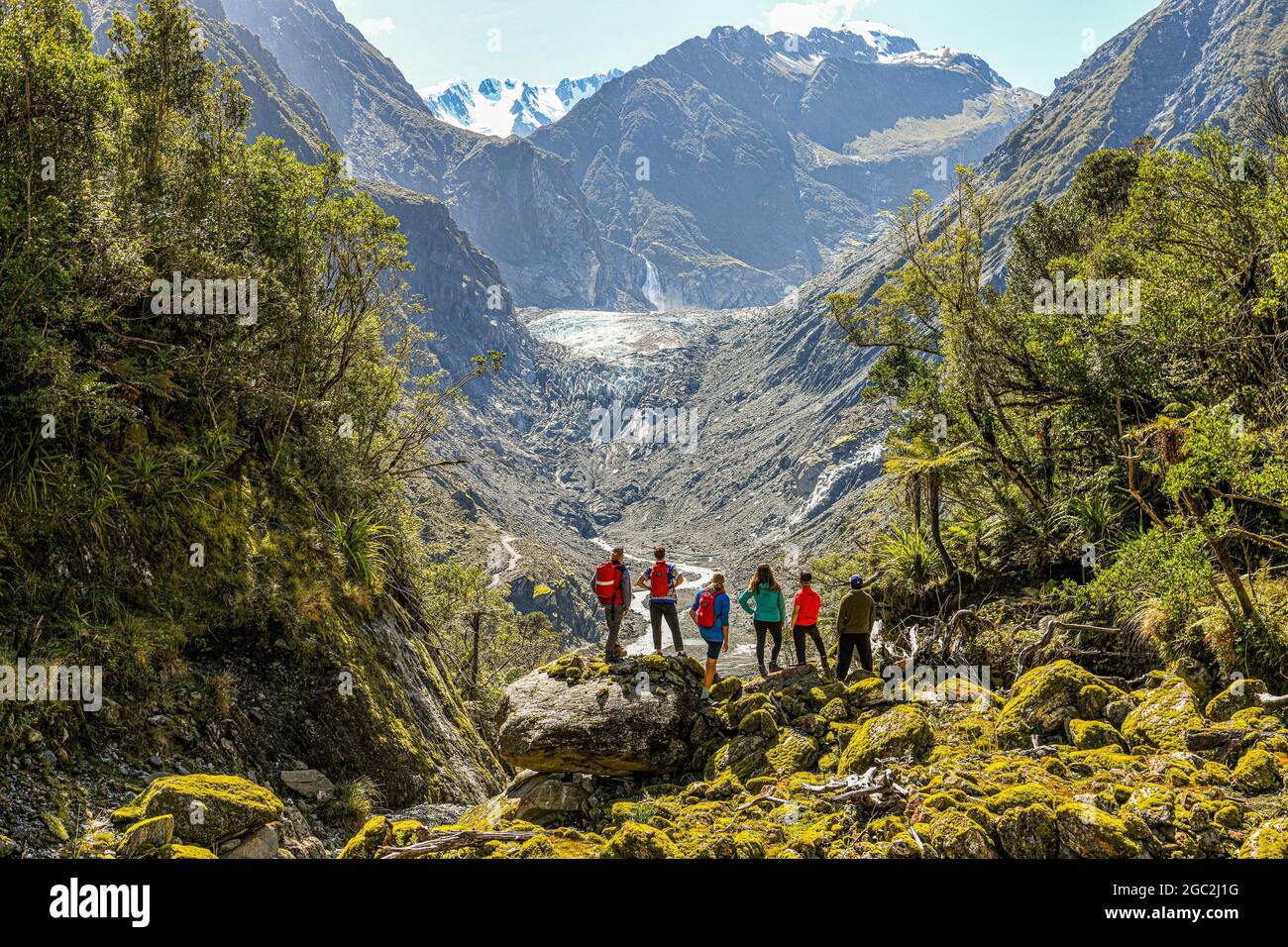 (210806) -- WELLINGTON, Aug. 6, 2021 (Xinhua) -- Hikers stand at the foot of Fox Glacier on the west coast of the South Island of New Zealand, Nov. 24, 2020.  New Zealand's Fox Glacier has long been an internationally renowned tourism attraction.    However, Rob Jewell, CEO of Fox Glacier Guiding, is deeply concerned about the cancellations of booking after the eight-week pause of Trans-Tasman travel bubble implemented in late July, usually the golden season for businesses of Fox Glacier township, a remote and small tour destination in New Zealand.   TO GO WITH 'Feature: New Zealand's remote t Stock Photo