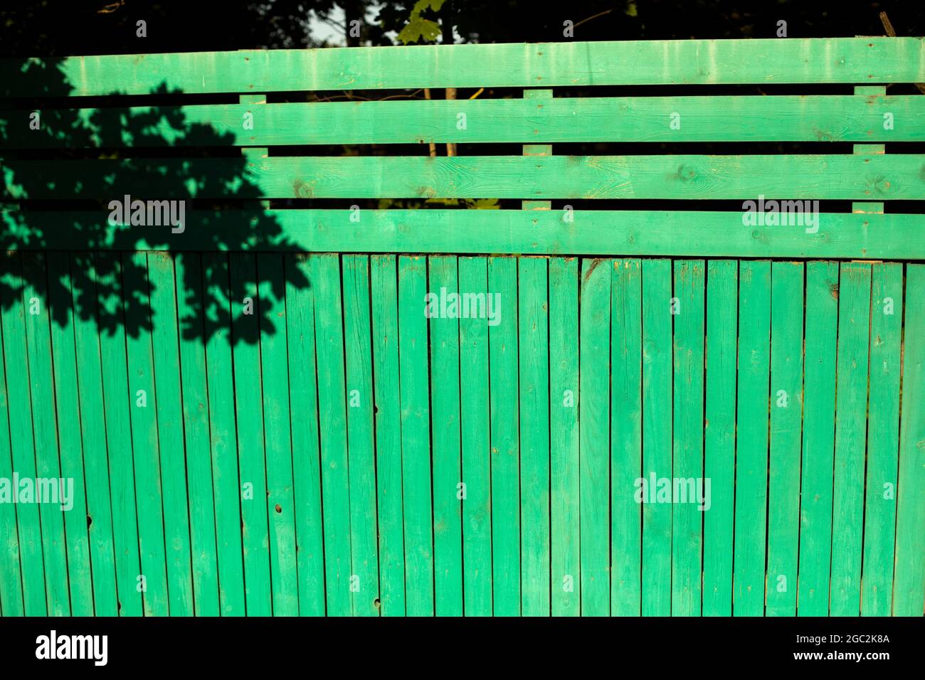 Green fence. Fence around the house. Details of the suburban area. Stock Photo
