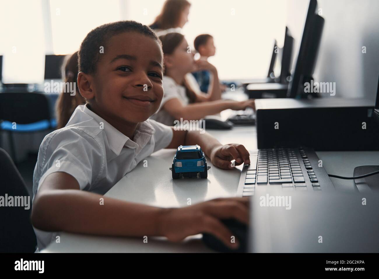 Adorable child learning how to use computer Stock Photo - Alamy