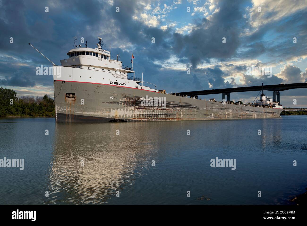 Freight ship passing under under Queen Elizabeth Way Garden City Skyway Welland Canal St. Catharines Ontario.  St. Lawrence Seaway  Great Lakes Waterw Stock Photo