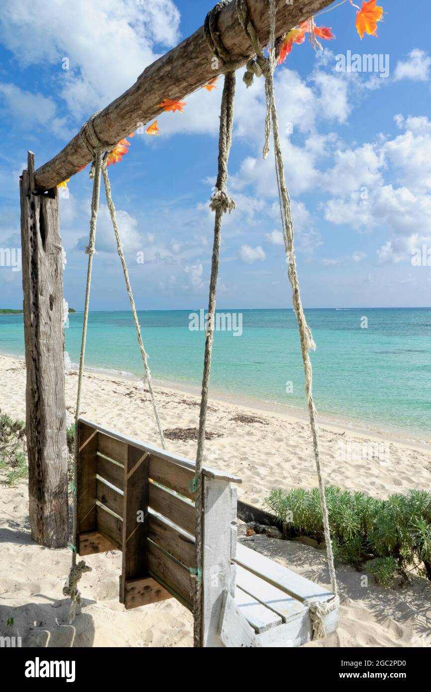 A rustic wooden swing in a tropical beachfront, Caribbean ocean island of  Cozumel, Mexico Stock Photo - Alamy