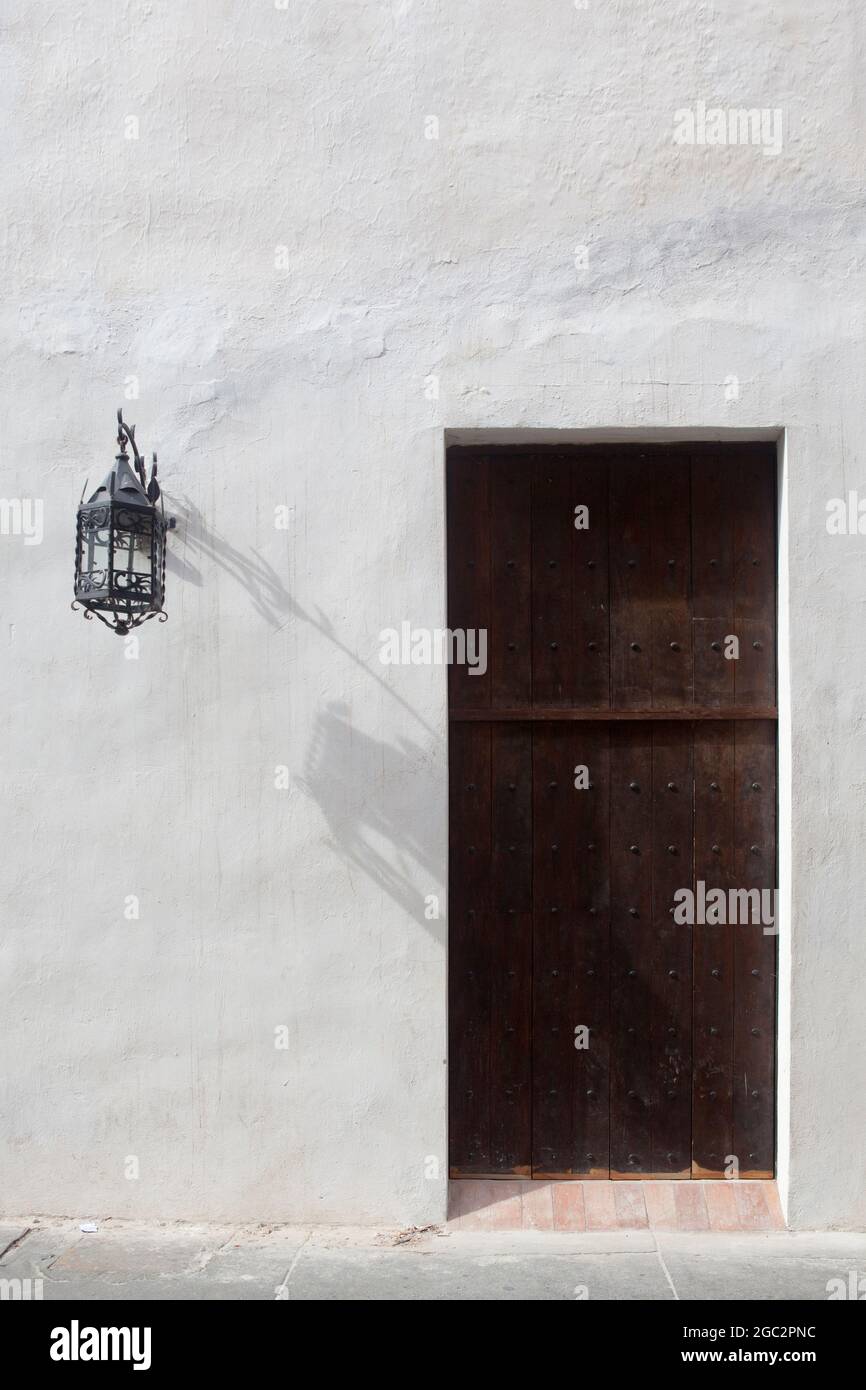 An ornate door and lamp on street level in Cartagena, Colombia Stock Photo