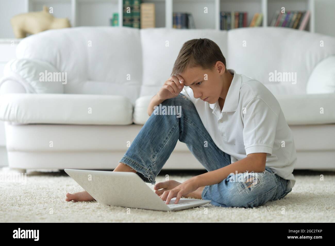 Portrait of boy using modern laptop at home Stock Photo - Alamy