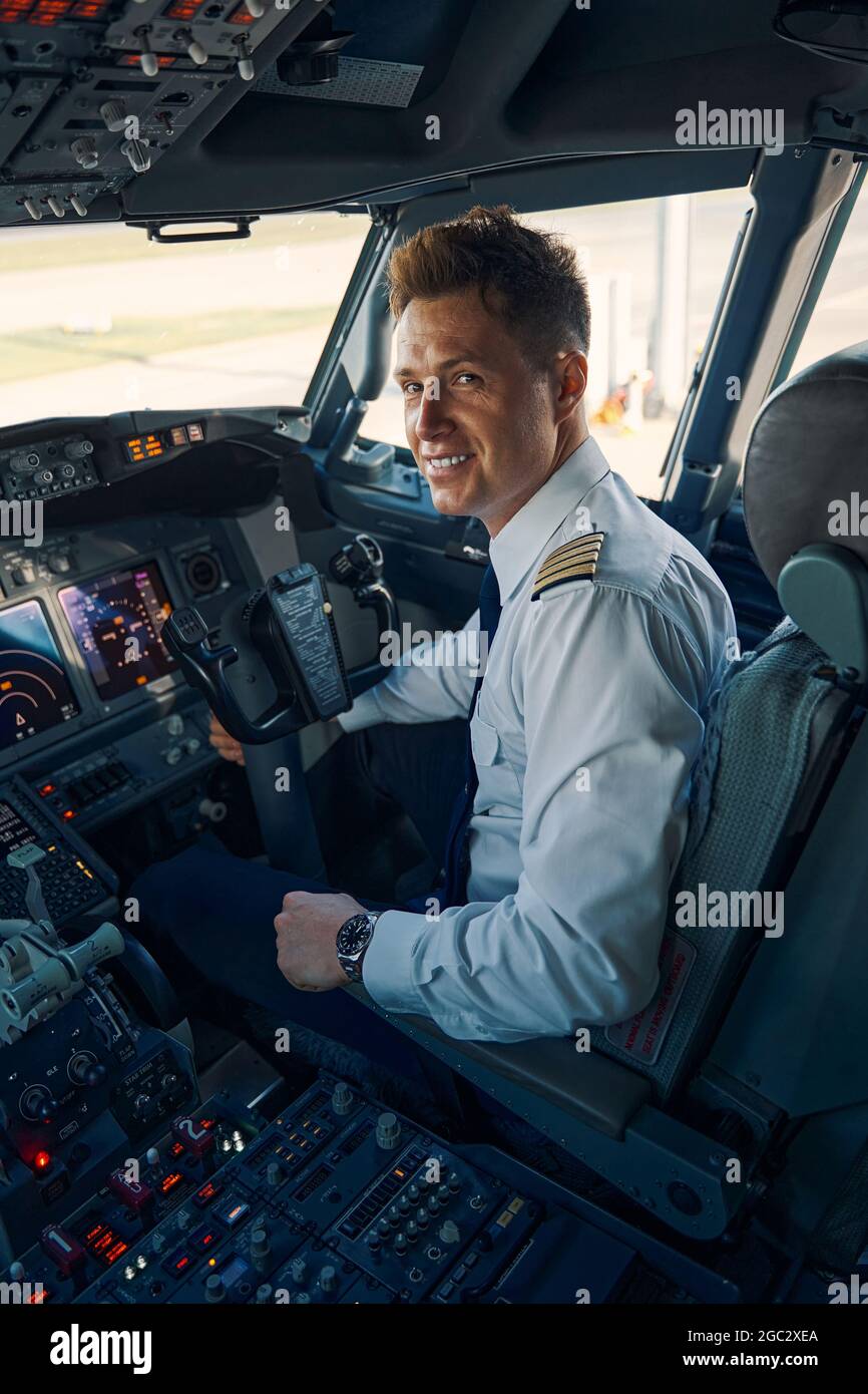 Pilot posing for the camera in the cockpit Stock Photo Alamy