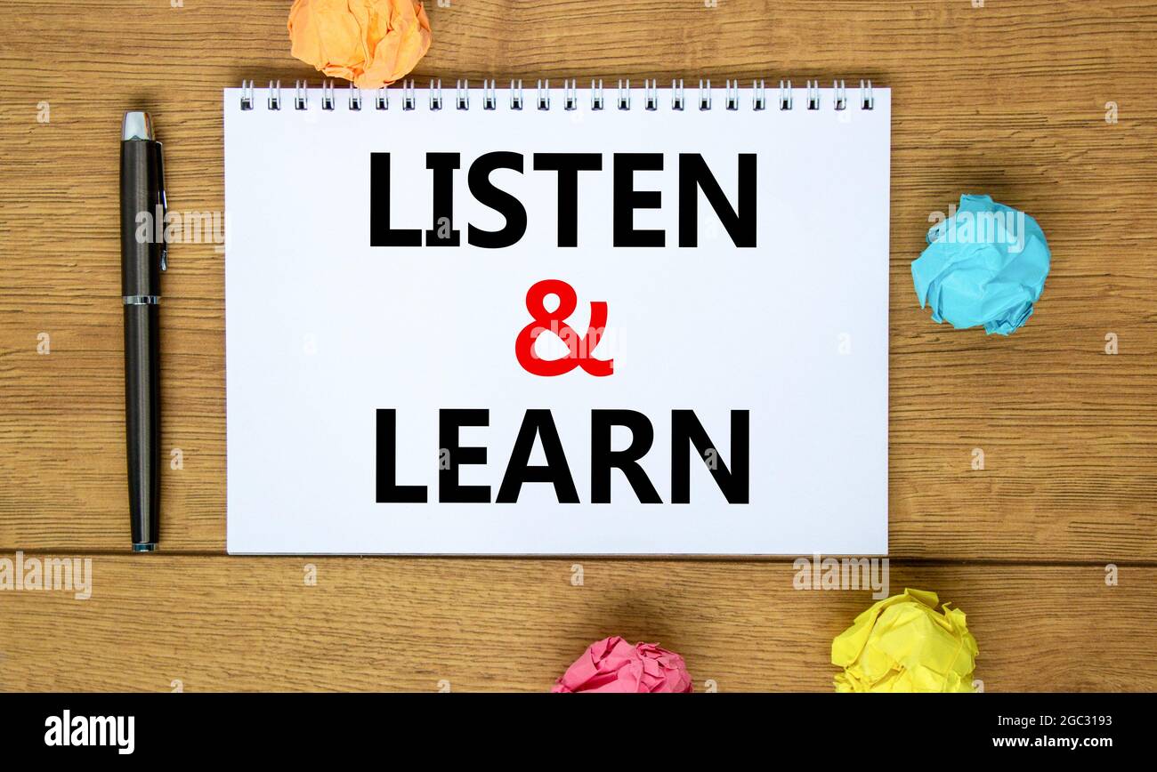 Listen and learn symbol. Words 'Listen and learn' on white note on ...