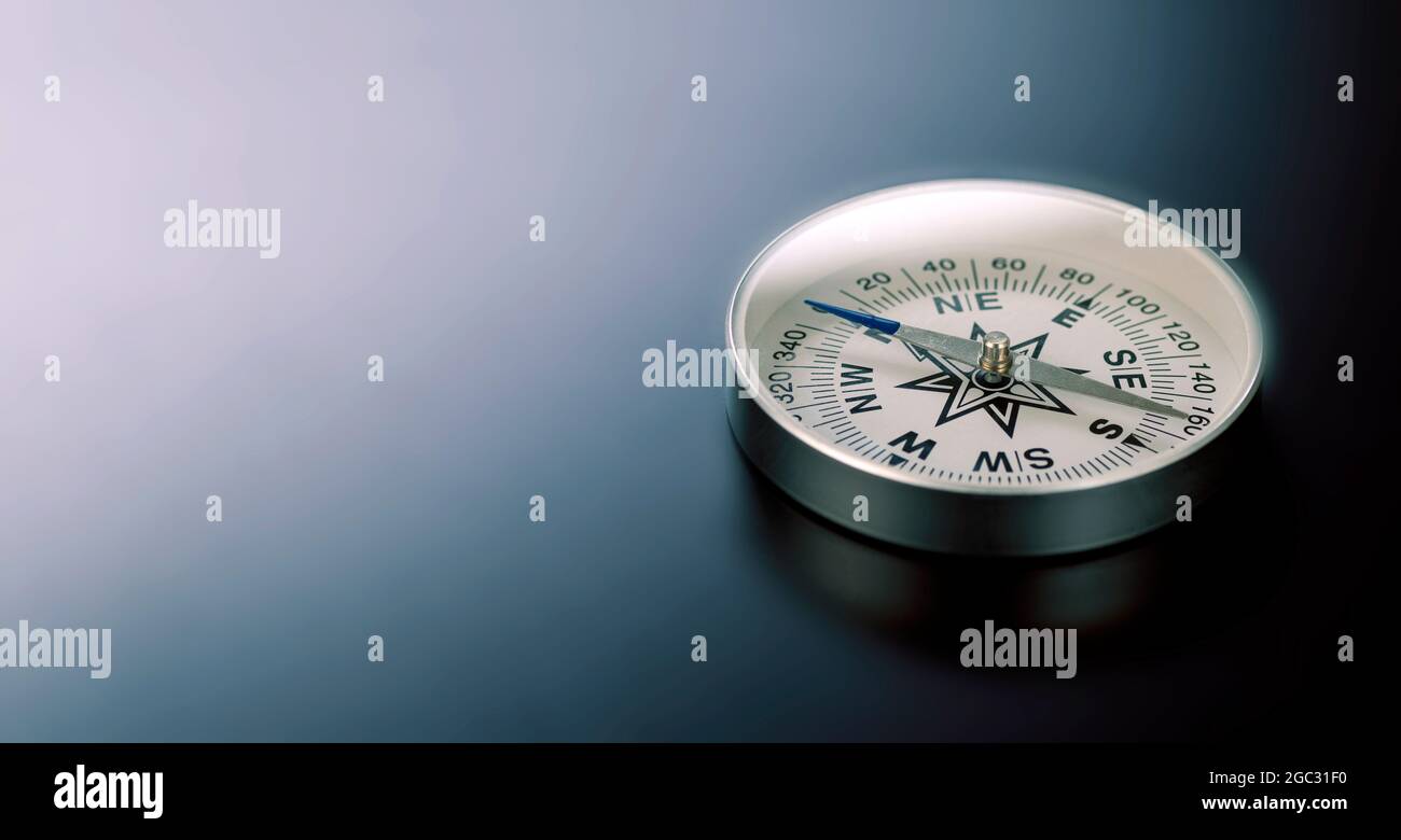 Compass on black board background and a lot of copy space. Concept - compass  showing the right direction in business, finance, self development or spi  Stock Photo - Alamy