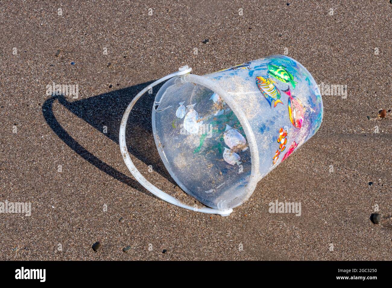 childs plastic bucket, seaside bucket, sandcastles on beach, abandoned