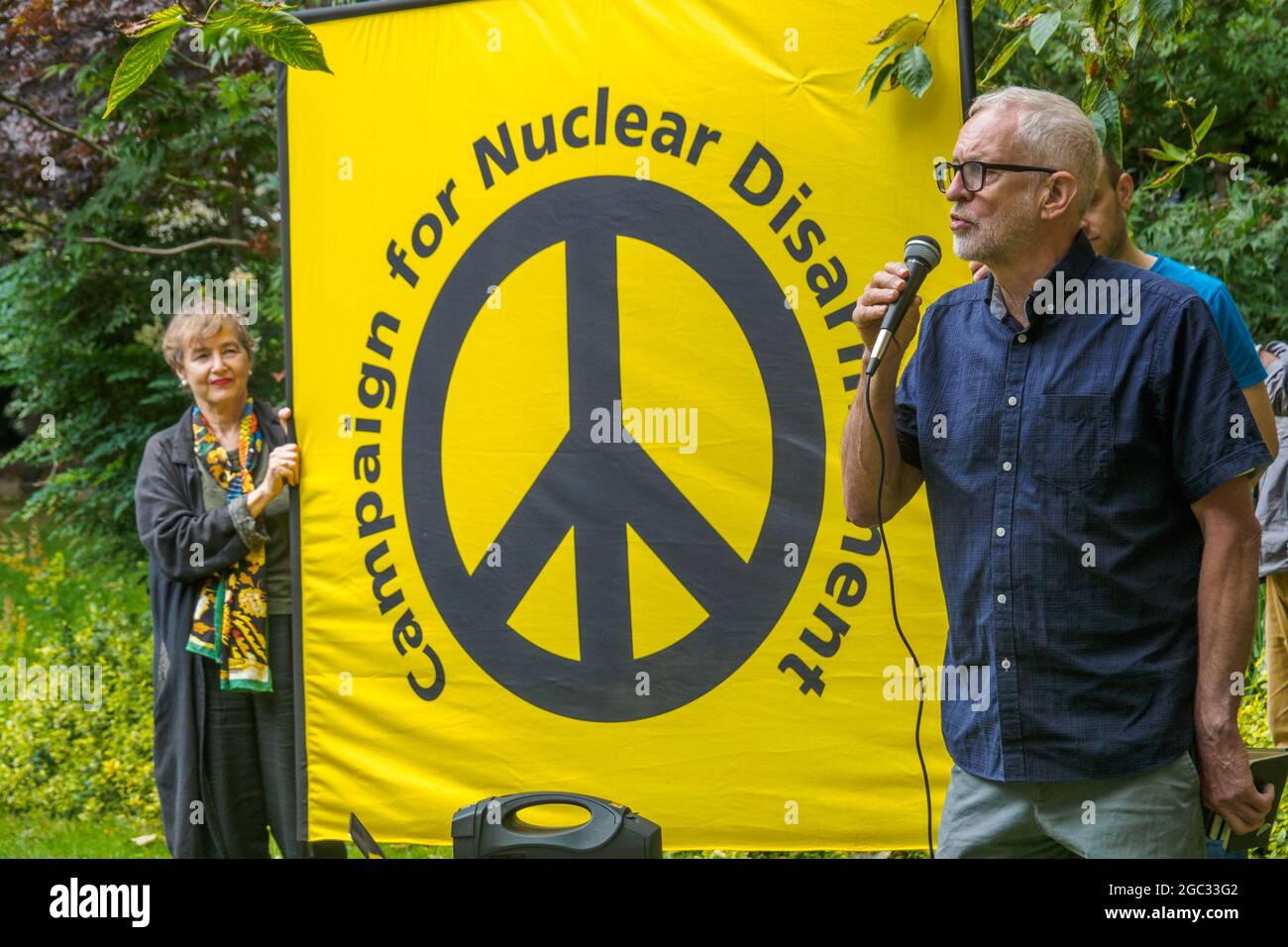 London, UK. 6th August 2021. Islington MP Jeremy Corbyn speaks. 76 years after atomic bombs were dropped on Hiroshima and Nagaski, London CND met at the Hiroshima Cherry tree in Tavistock Square to remember the many killed and survivors who are still suffering the event, and to celebrate the UN treaty prohibiting nuclear weapons which came into force this January. They called on the government to end the UK's nuclear weapon programme. Peter Marshall/Alamy Live News Stock Photo